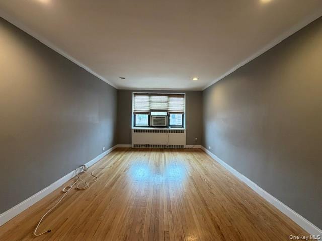 Hardwood flooring, recessed lighting, window, crown molding, and a window air conditioning unit