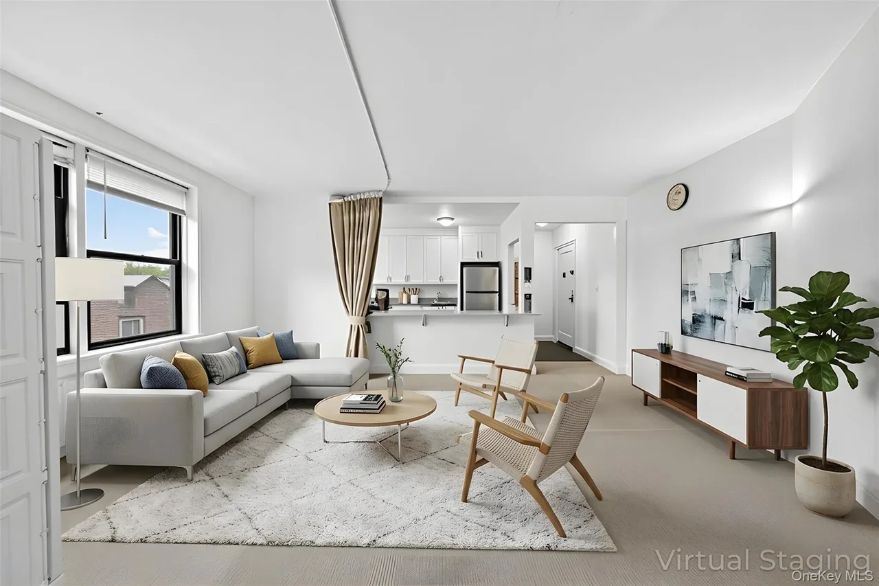 Open-concept living space featuring a spacious layout, large windows, recessed lighting, and light neutral wall colors